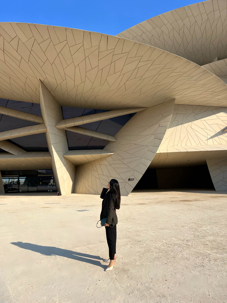 Art advisor standing before the National Museum of Qatar in Doha, designed by Jean Nouvel — AN Art Advisory Middle East presence