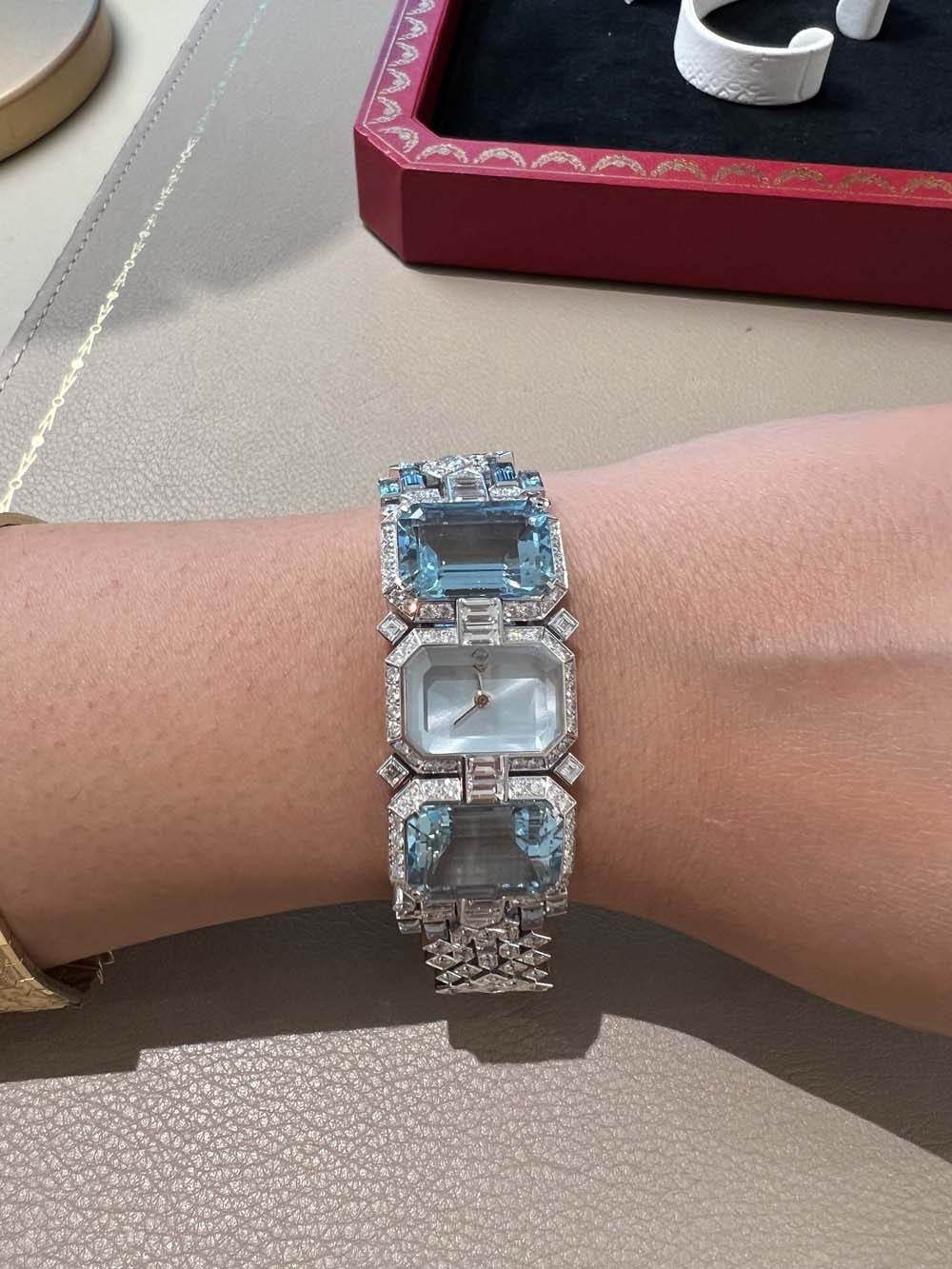 Vintage Art Deco bracelet watch with large rectangular aquamarine panels and diamond pavé bezel, worn on wrist — antique jewelry advisory and valuation
