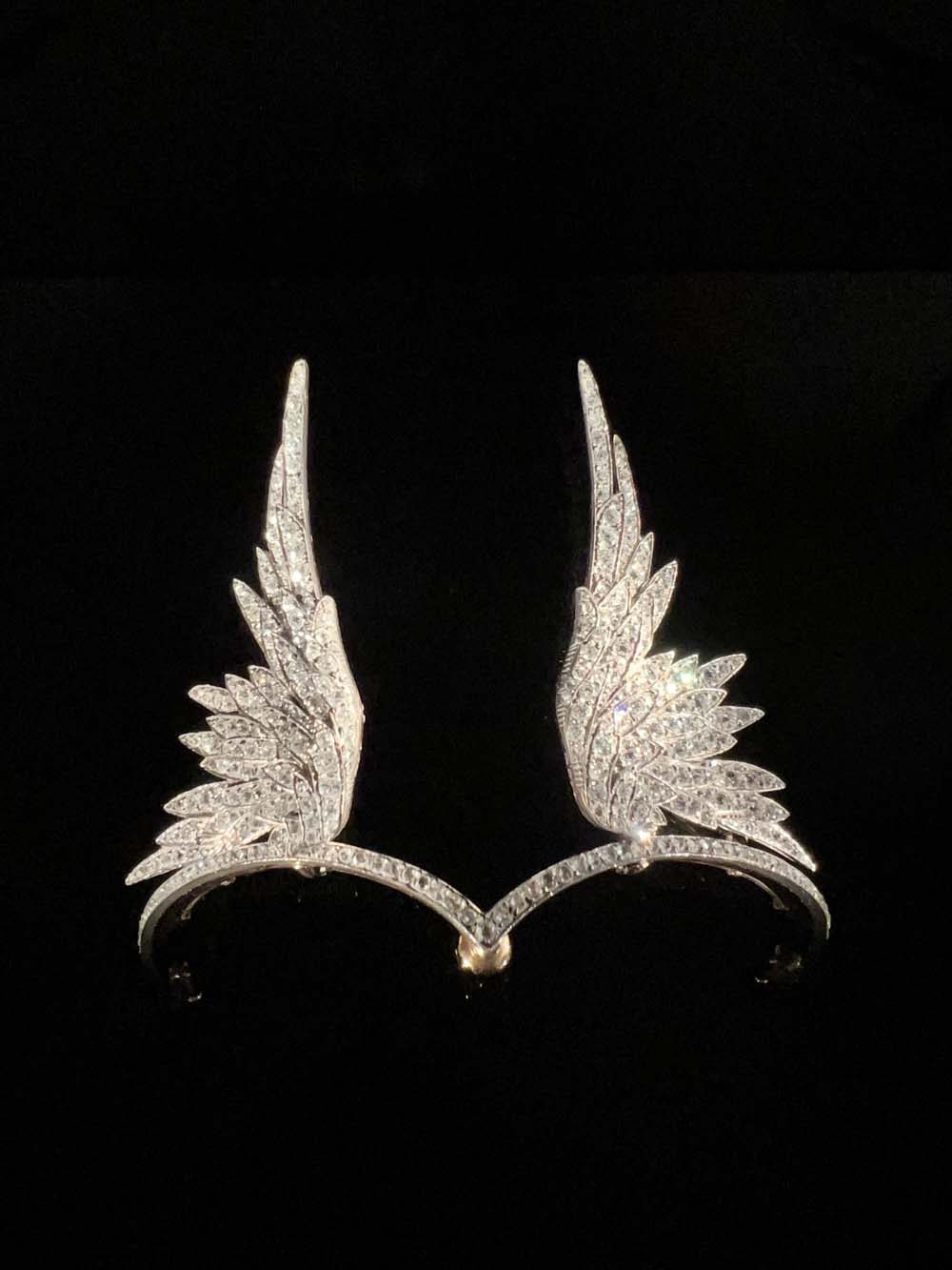 Antique diamond wing diadem with two feathered wings entirely pavé-set with diamonds, on a dark background — fine jewelry advisory and valuation