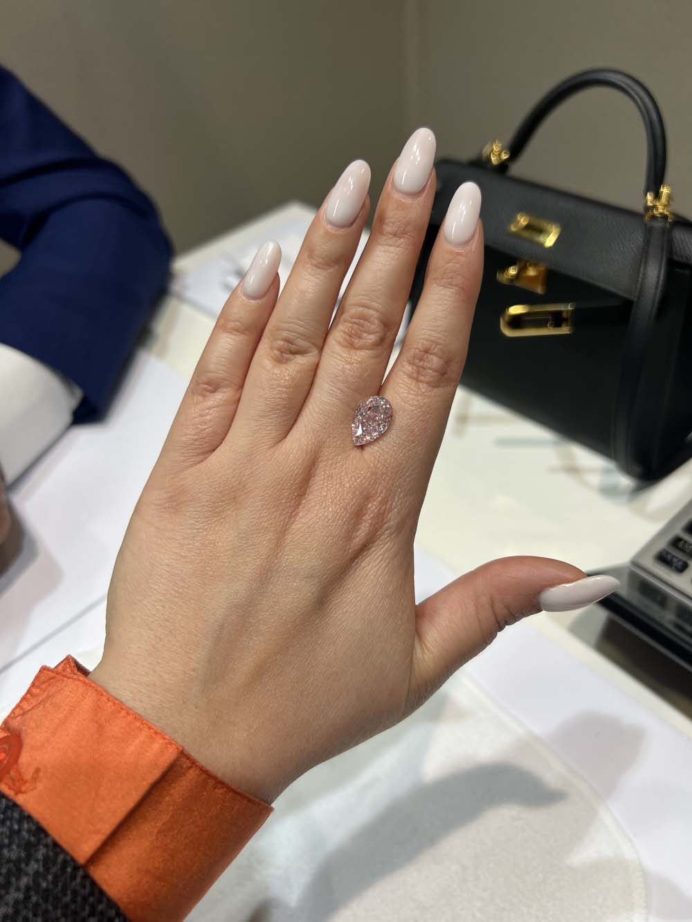 Fancy pink pear-shaped natural diamond ring shown on hand — rare natural diamond advisory and collection