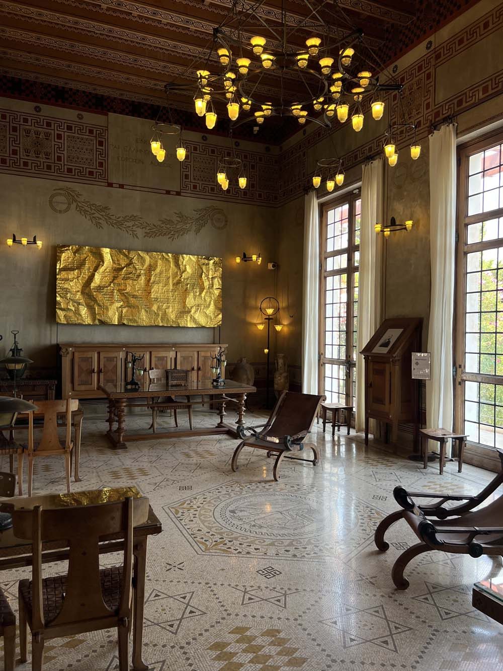 Historic Italian sala with vaulted painted ceiling, mosaic floor and a contemporary gold artwork on the wall — art appraisal in historic collections